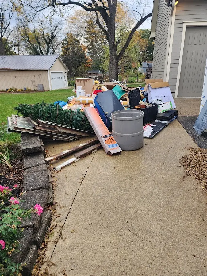 Dumpster being loaded with debris for Roofing Dumpster Rental in Hazel Park